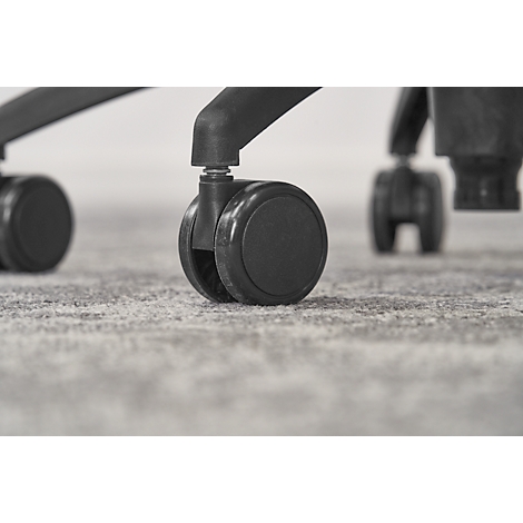 Close-up of black chair casters sitting on a gray textured carpet. Chair is partially in view.
