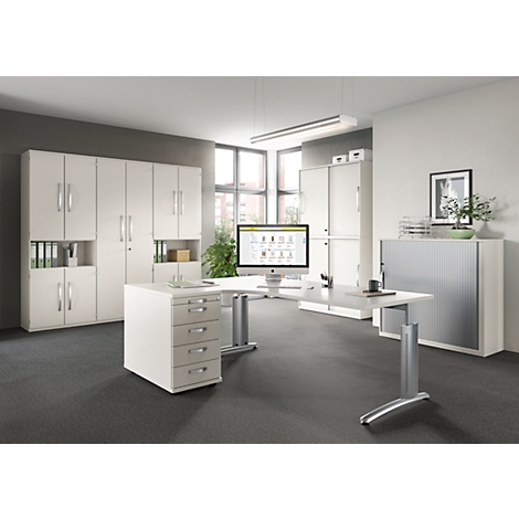 Bright office with white desk, file cabinets, and a computer screen.