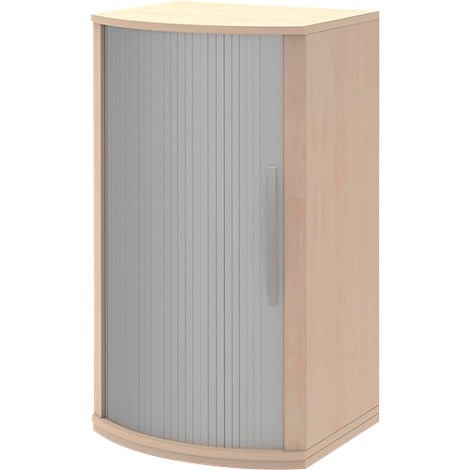 Corner cabinet in light brown, with a ribbed, gray tambour door and light handle.