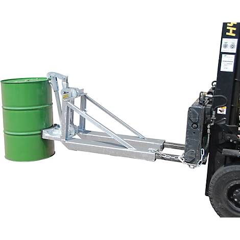 Forklift holding a green barrel. The barrel is held by a silver lifting device.