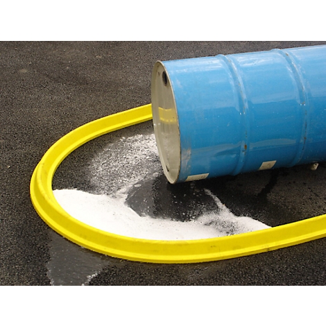 Blue barrel lying with white powder, yellow safety barrier, gray asphalt.