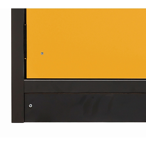 Close-up of a cabinet door. Yellow above, black below. Angular shape.
