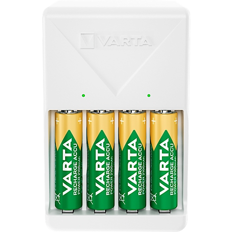 A white battery charger with four inserted AA batteries. The batteries have yellow and green prints with the brand name VARTA.