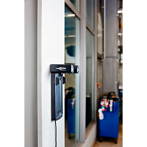 A black device labeled "AirScanner" on a white wall. It has headlights and a plate.