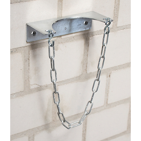 Metal fire extinguisher bracket on brick wall. Chain to secure the fire extinguisher.