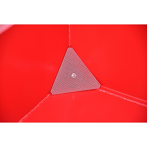 Close-up van een rood oppervlak. In een hoek zit een driehoekig, geperforeerd element met een schroef in het midden.