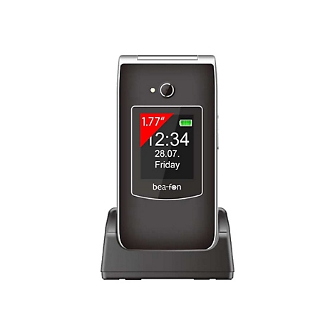 Ein schwarzes Klapphandy in einer Ladestation. Auf dem Display: Uhrzeit, Datum und Schriftzug 'bea-fon'.