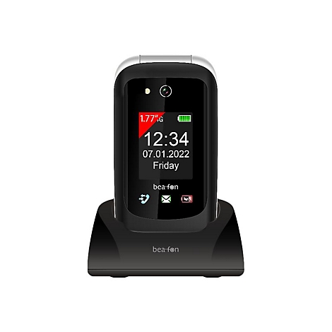 Schwarzes Klapphandy in Ladestation. Uhrzeit 12:34, Datum 07.01.2022, Freitag. Schriftzug 'bea-fon'.