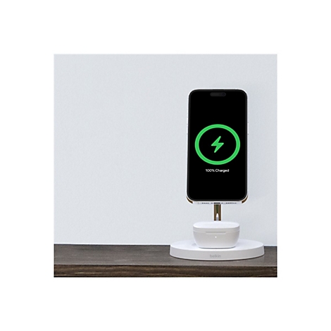 Smartphone, das kabellos geladen wird. Ladestation mit 100% Ladezustand, Ohrhörer-Ladecase.