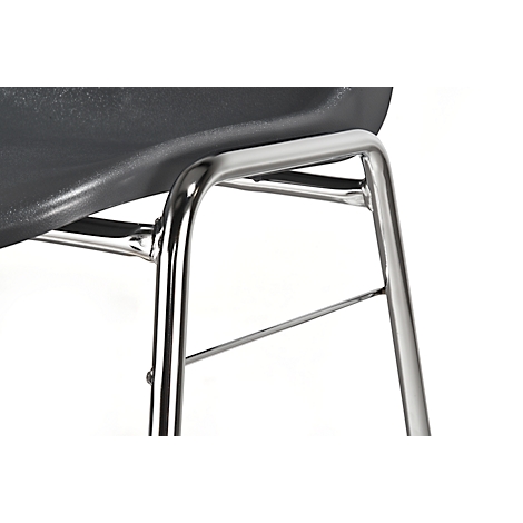 Close-up of a chair leg made of shiny metal and a black seat against a white background.