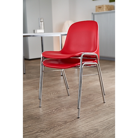 Two red chairs with chrome legs, stacked on a wooden floor.