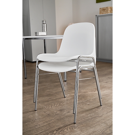 White chair with chrome legs. In the background a table, a bottle and a cabinet.