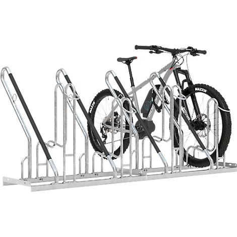 Bicycle stand with a mountain bike. The stand is made of metal, the wheel is gray with black tires.
