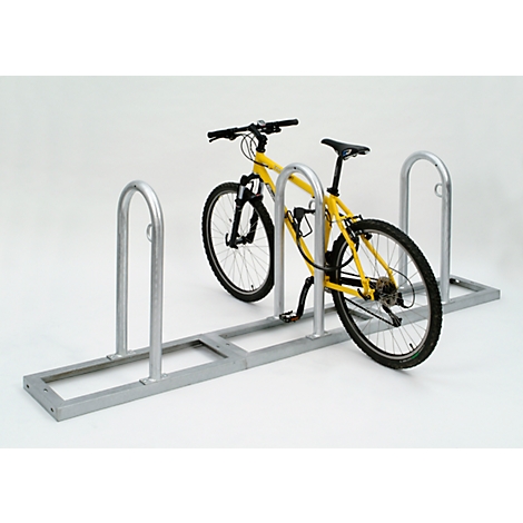 Yellow bicycle in a metal bike rack.