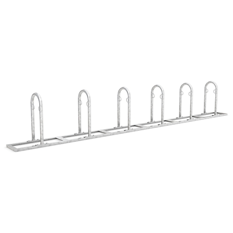 Metal bicycle rack with 7 loops in a row.