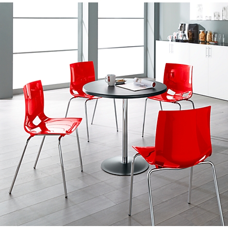 Red chairs surround a black table. Coffee cup and papers on the table.