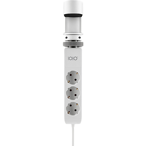 Un appareil blanc avec trois prises. En haut se trouve un anneau noir et l'inscription "1010".