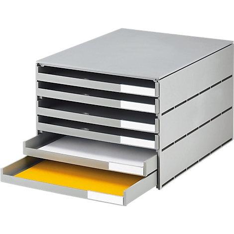 Système de tiroirs gris avec six compartiments, deux tiroirs ouverts. Papier blanc visible en haut à gauche, jaune en bas.
