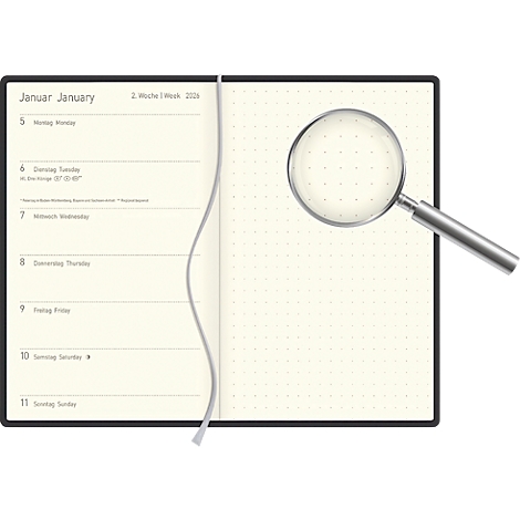 Opened notebook with a magnifying glass. The pages have a calendar. January and KW 2 are written at the top. The magnifying glass is on the empty page.