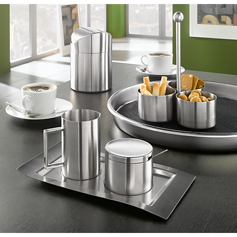 Stainless steel coffee service with cups, sugar bowl, and serving dishes, all set on a table.