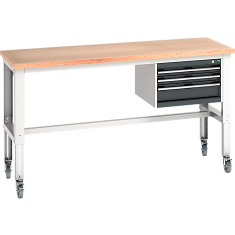 Workbench with wooden top, gray legs and castors. Side with drawers. Close-up.
