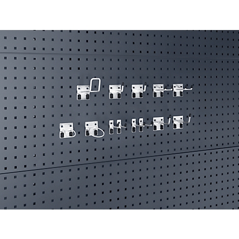 Graue Lochwand mit verschiedenen weißen Haken, die in die Löcher eingehängt sind.