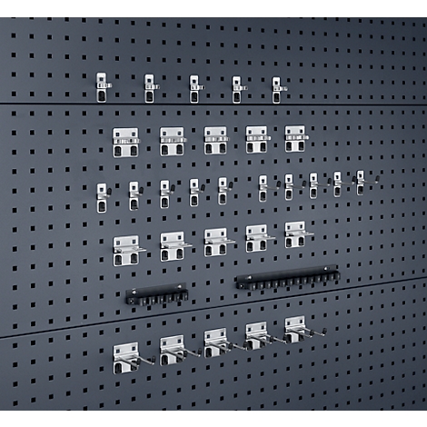 Grijze pegboard met diverse gereedschapshouders.