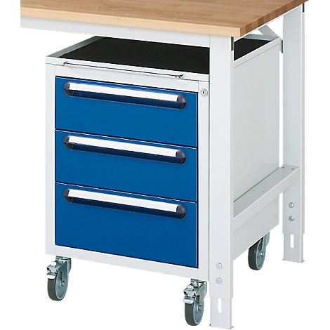 Blue painted drawer cabinet with three drawers, castors, and under a wooden workbench. Drawers with silver handles.