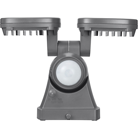 Grijze buitenlamp met twee lampen en een bewegingsdetector. De lamp is van bovenaf gefotografeerd, waarbij de achterkant zichtbaar is.