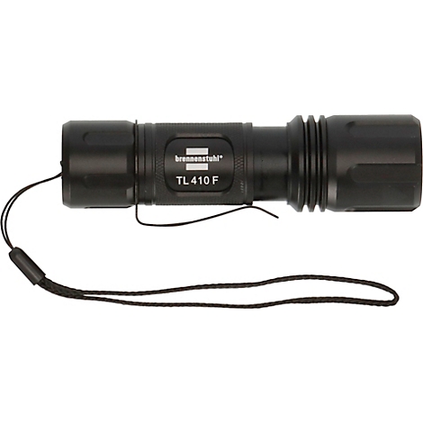 Zwarte zaklamp met de tekst TL 410 F en een handlus.
