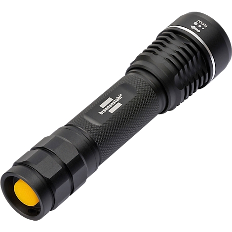 Lampe de poche noire avec lumière jaune, nom de la marque "brennenstuhl". Fonction zoom et surface rainurée.
