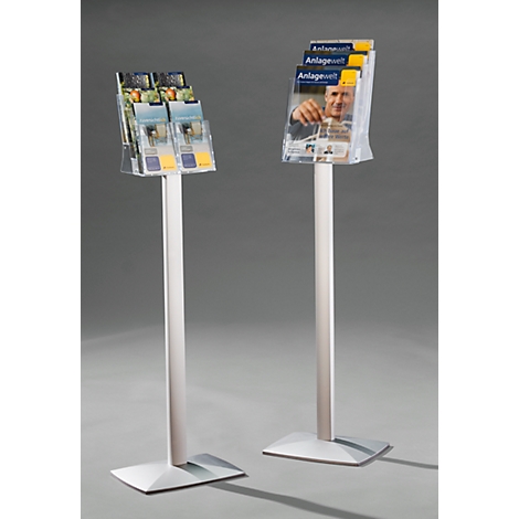 Two silver brochure stands with brochures in plastic compartments. One says "Anlage Welt".
