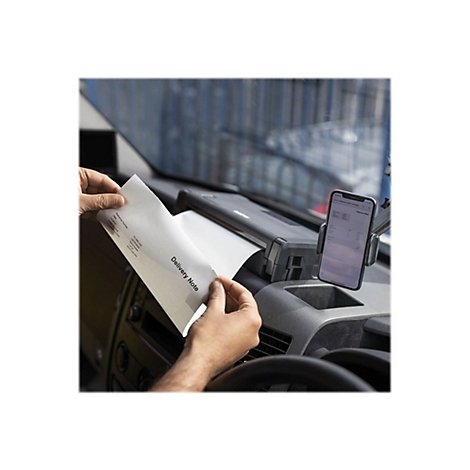 Person hält in einem Fahrzeug einen Lieferschein. Daneben ist ein Smartphone in einer Halterung zu sehen.