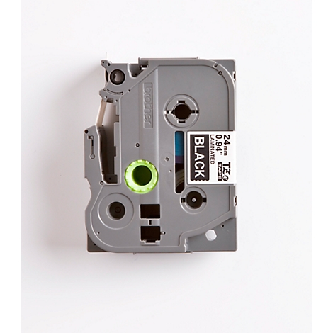 Grey label cassette with green circle and white label with black text: BLACK, 24mm LAMINATED, 0.94".