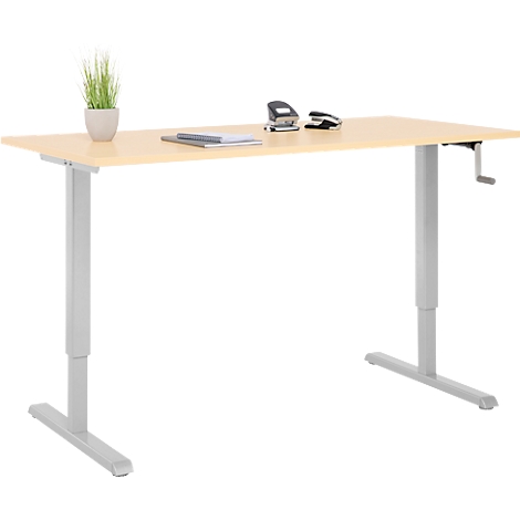 Bureau réglable en hauteur avec bois clair, pieds gris et manivelle. Sur le bureau : plantes, perforatrice, bloc-notes.
