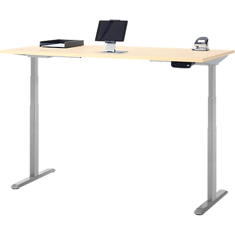 Bureau réglable en hauteur de couleur claire avec tablette et perforatrice.