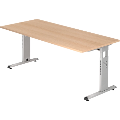 Bureau beige avec pieds gris réglables en hauteur. Le plateau est rectangulaire et les pieds en forme de T.