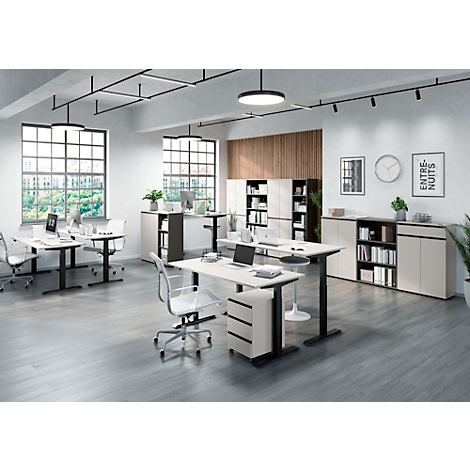 Kantoor met meerdere bureaus, stoelen, kantoorkasten en ramen.