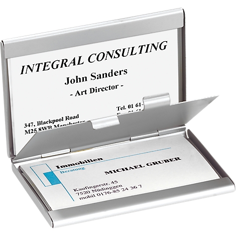 Open silver business card case filled with cards. Printed names and contact details.