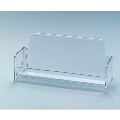 Transparent business card holder made of acrylic glass, with back and side parts. The holder stands on a light blue surface.