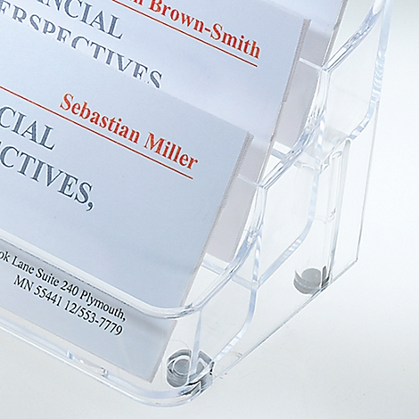 Close-up of a clear card holder with business cards. Names and contact information are visible on the cards.