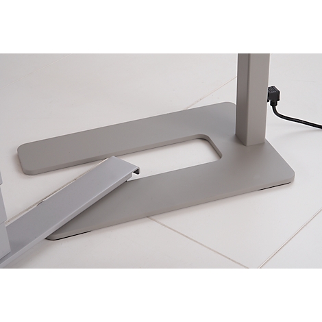 Close-up of the silver base of a standing table with a protruding detail.