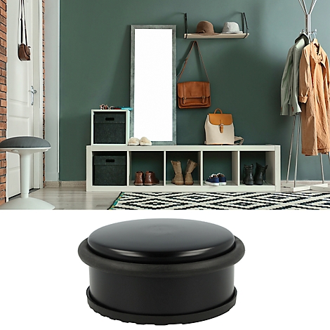 Butoir de porte noir, placé dans un couloir.
