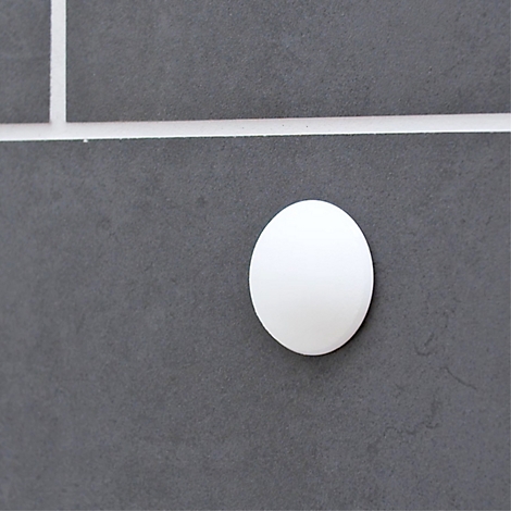 Un élément blanc ovale sur fond gris. Des lignes divisent le fond en carrés.