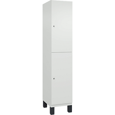 Hoher, weißer Schrank mit zwei Türen und schwarzen Füßen.