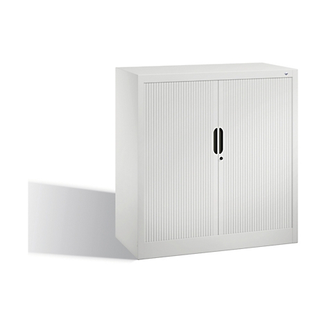 White filing cabinet with ribbed doors, black handle, and shadow.