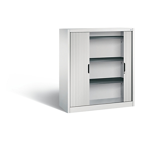 White cabinet with roller shutter, two black handles and three shelves. Cabinet stands against a white background.