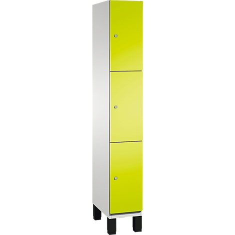 Schrank mit drei Türen, weiß und gelb, auf schwarzen Füßen.