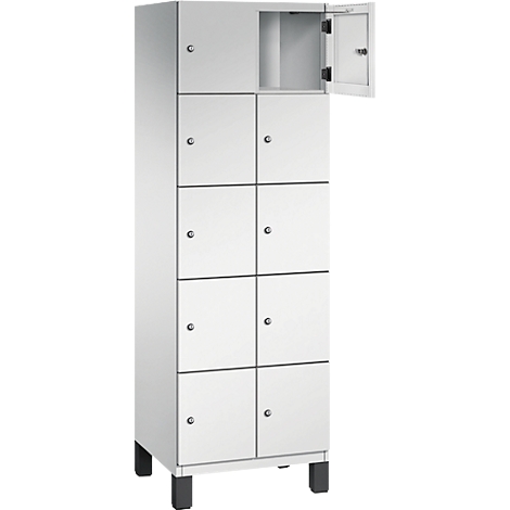 Weißer Spind mit acht Fächern und einer geöffneten Tür. Der Spind steht auf schwarzen Füßen.