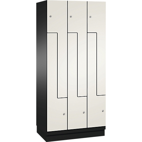 Schrank in Weiß und Schwarz. Der Schrank hat drei Türen mit schwarzen Linien und kleinen silbernen Knöpfen.